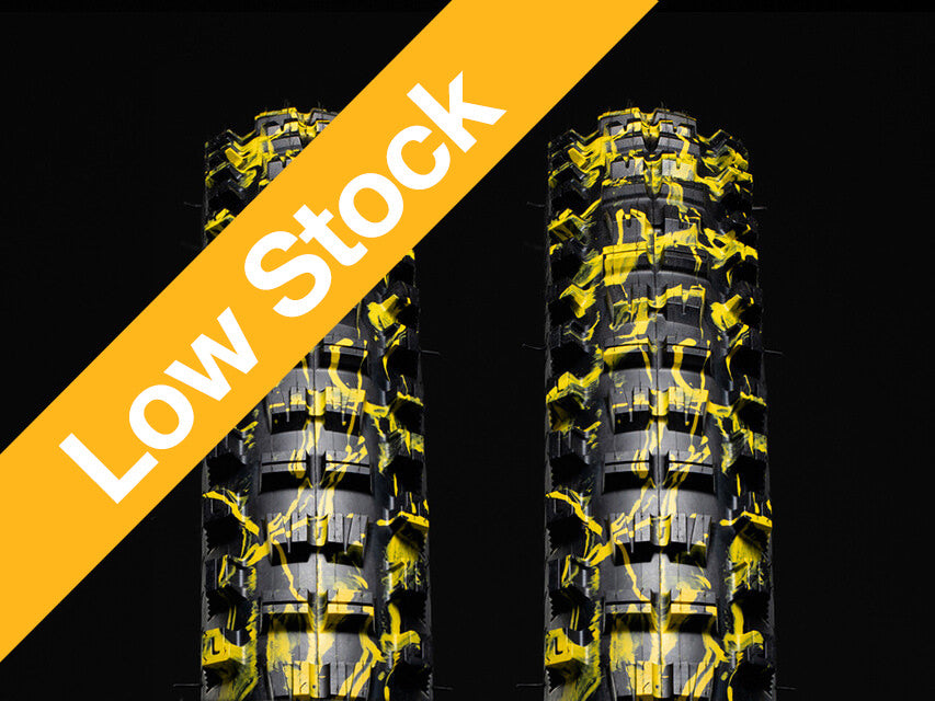 Two yellow splatter versus tires with low stock text