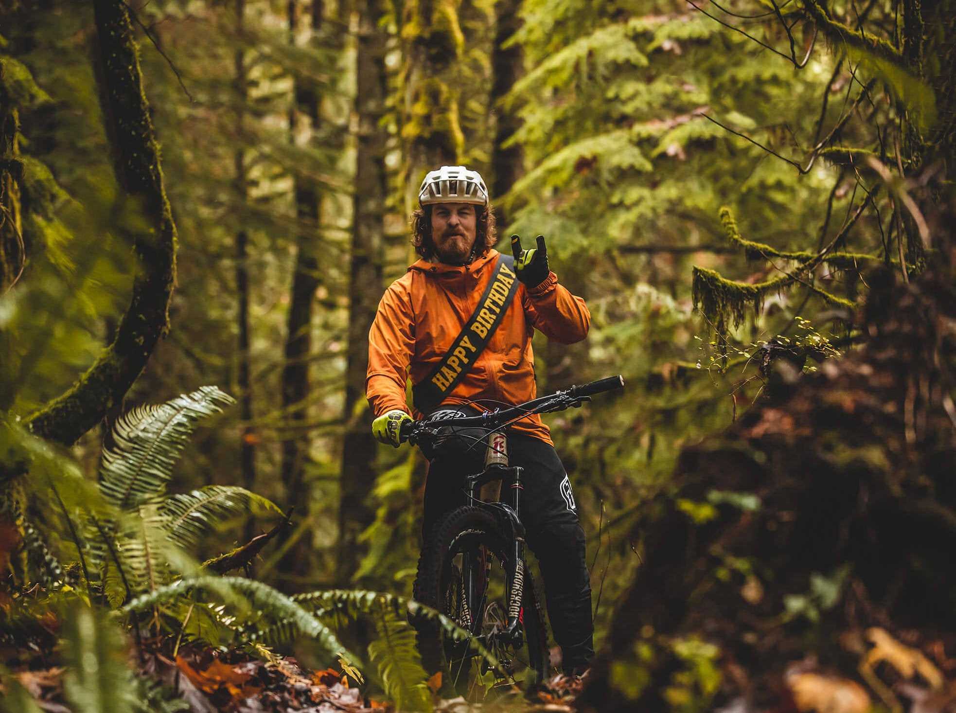 Person with a mountain bike in a forest setting