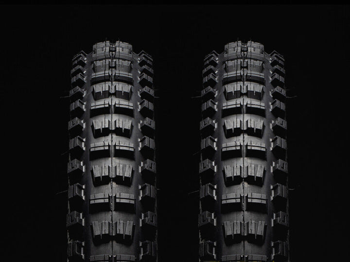 Two black Versus All-Mountain bicycle tires