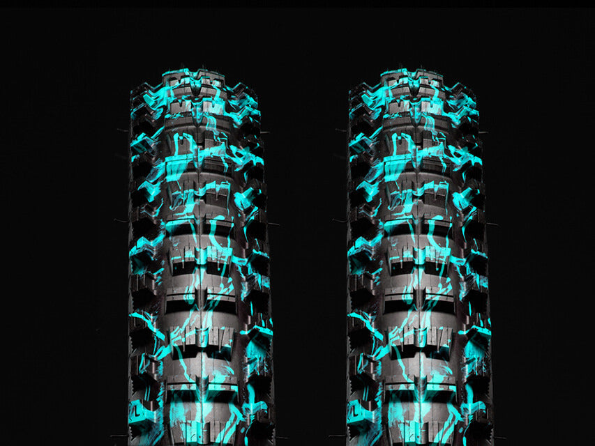 Two blue splatter Versus All-Mountain bicycle tires