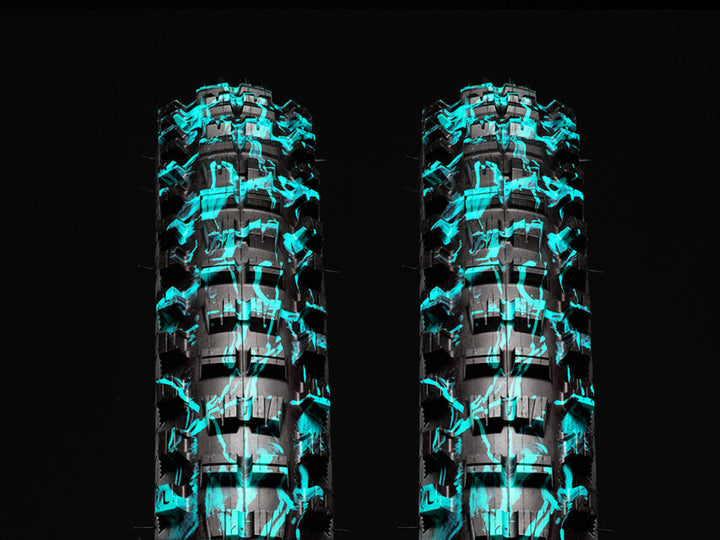 Two blue splatter Versus All-Mountain bicycle tires